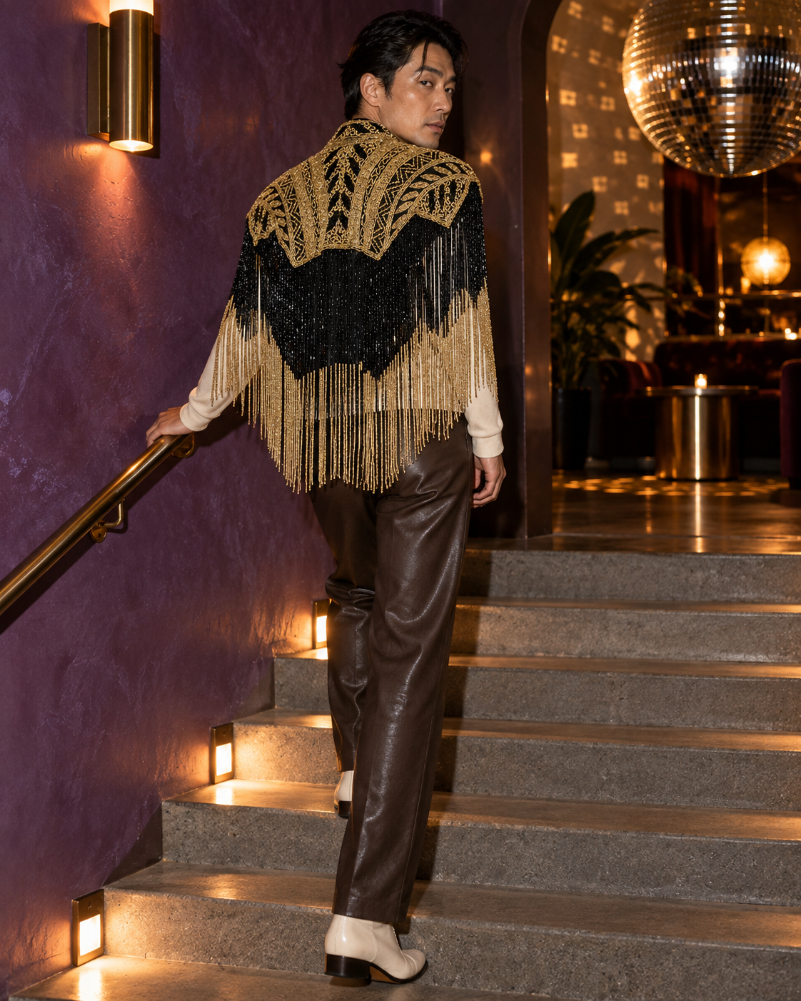 Model wearing The Jackson on a purple staircase beneath a mirror ball