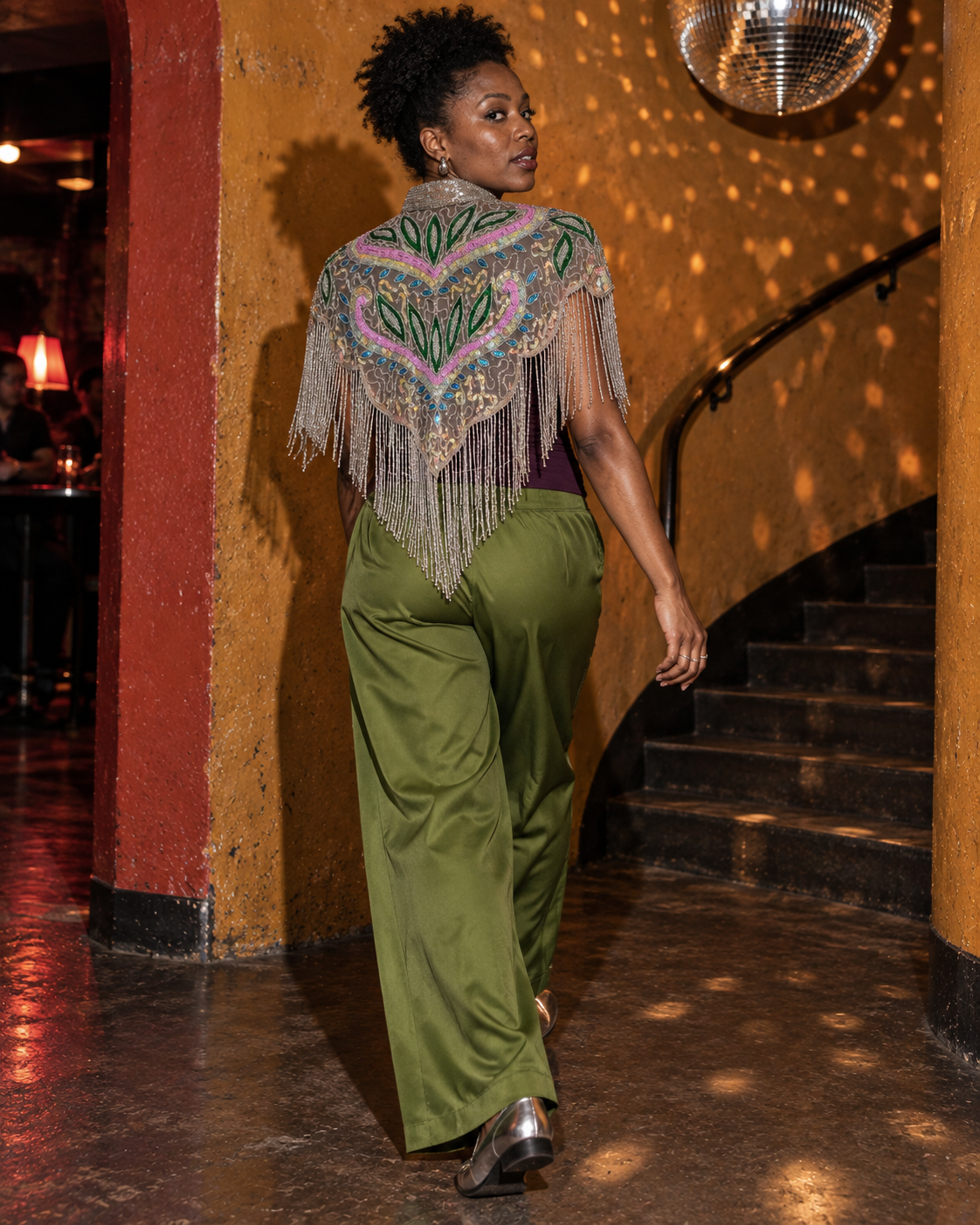 Model wearing The Paradise Lost in a warm, mirror-lit interior